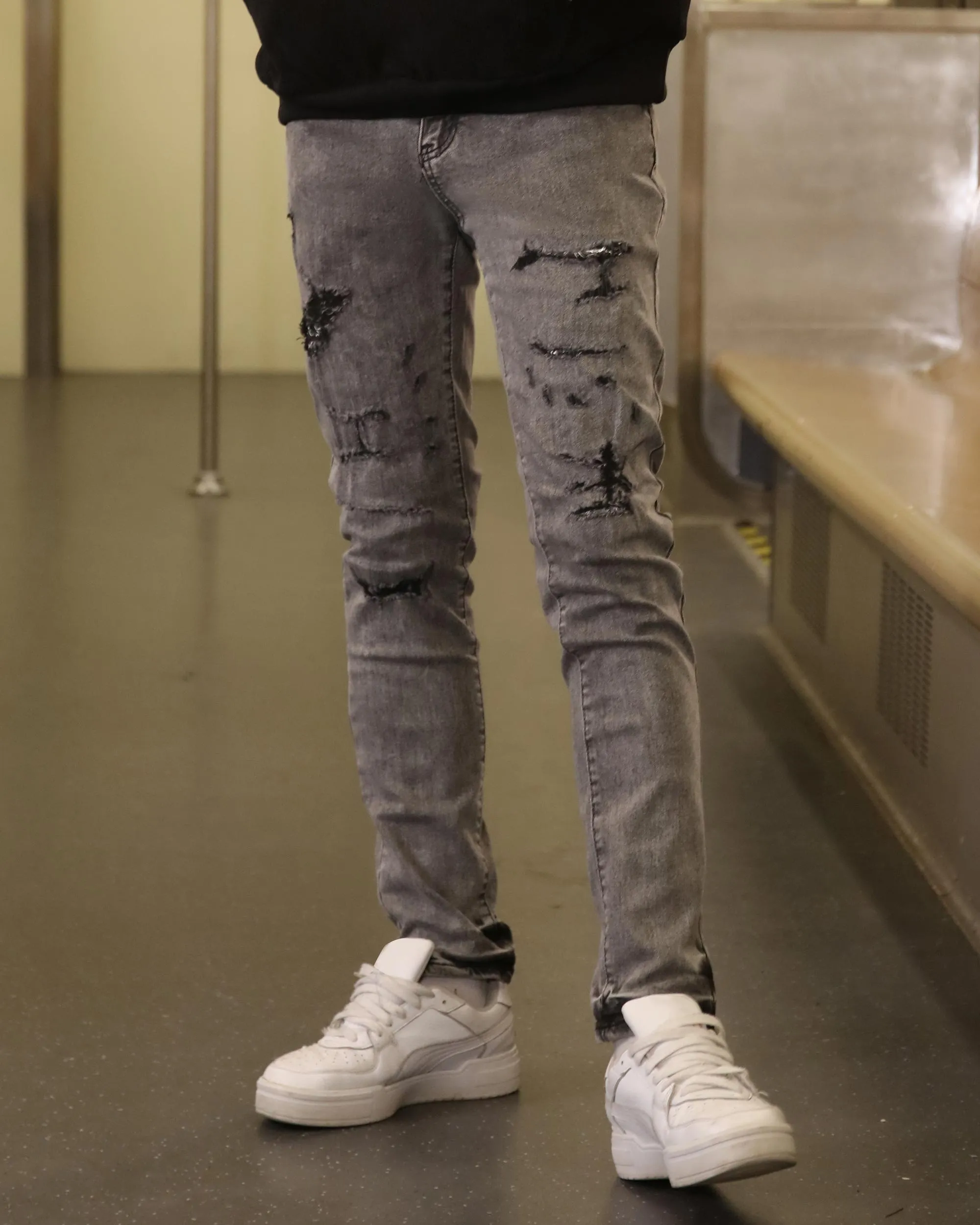 Gray Ripped Jeans with Graffiti-Inspired Style